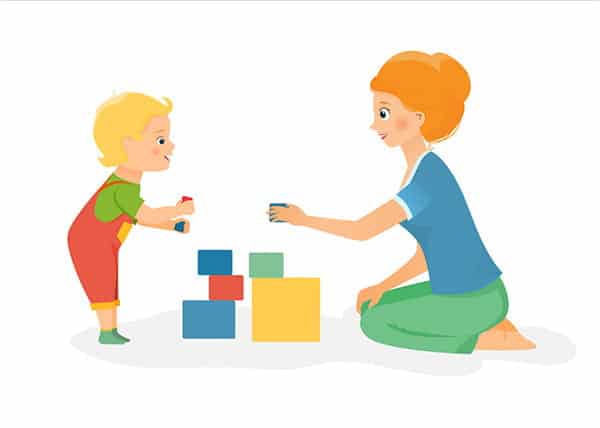 Boy and mother playing with blocks
