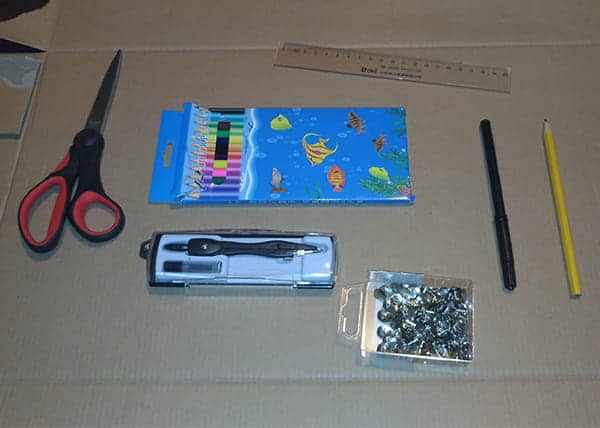 Materials for the cipher wheel: cardboard, scissors, pin, ruler, and markers